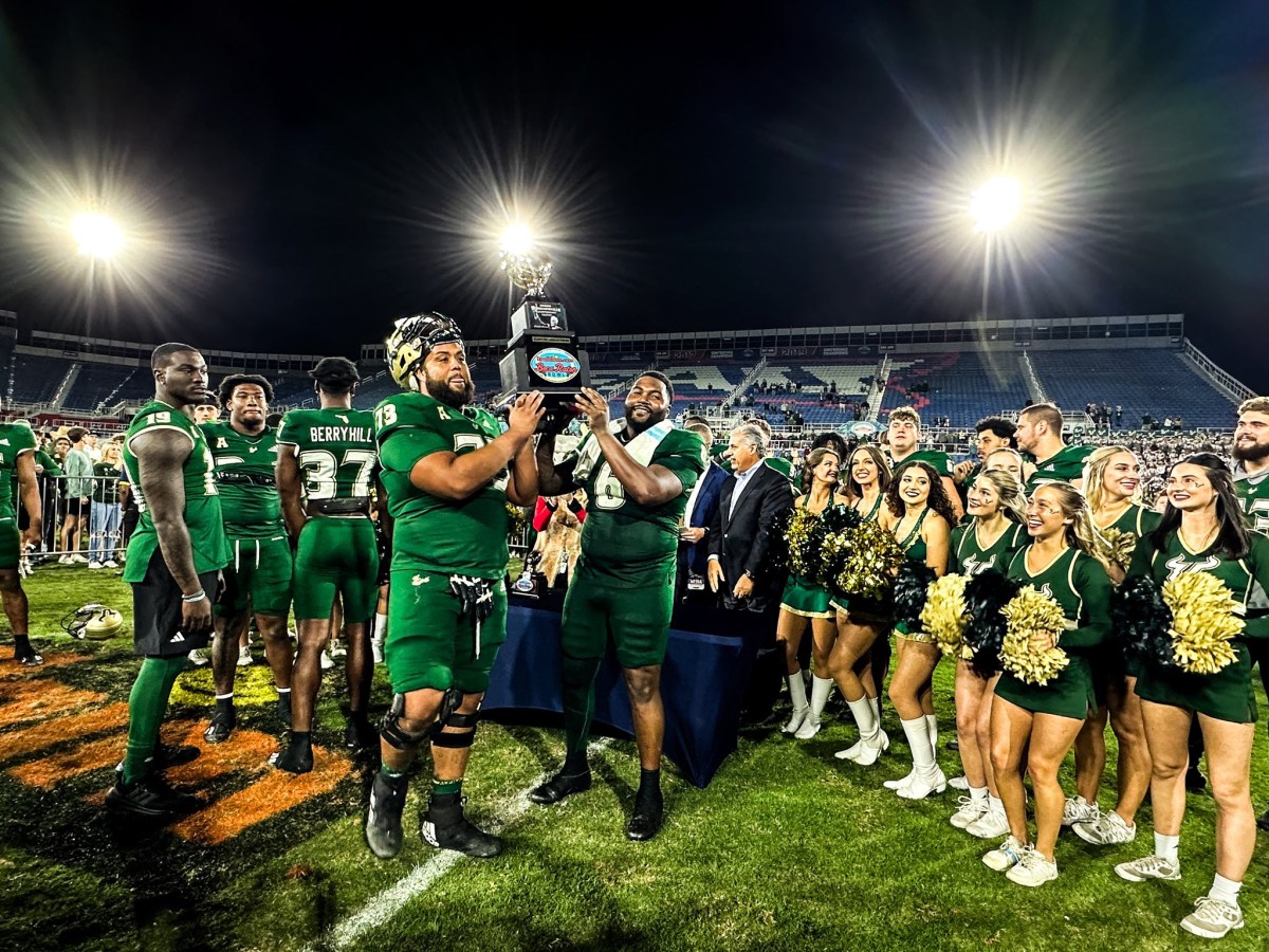 Byrum Brown throws three touchdown passes, guiding USF to an impressive 45-0 victory against Syracuse, who were facing a shortage of players, in the Boca Raton Bowl